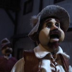 Sancho tries to stop Don Quixote during the tirade at the puppet show
